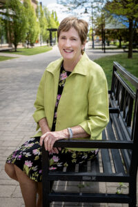 Peggy Frisbie sitting on a bench outside